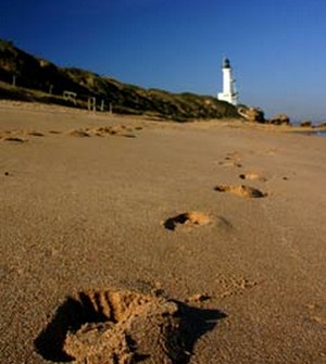 Photo of lighthouse and footprints